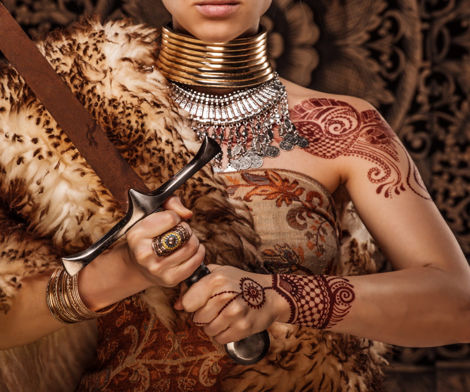Beautiful Blonde Sword wielding viking warrior female in Game of Thrones style covered in henna tattoos